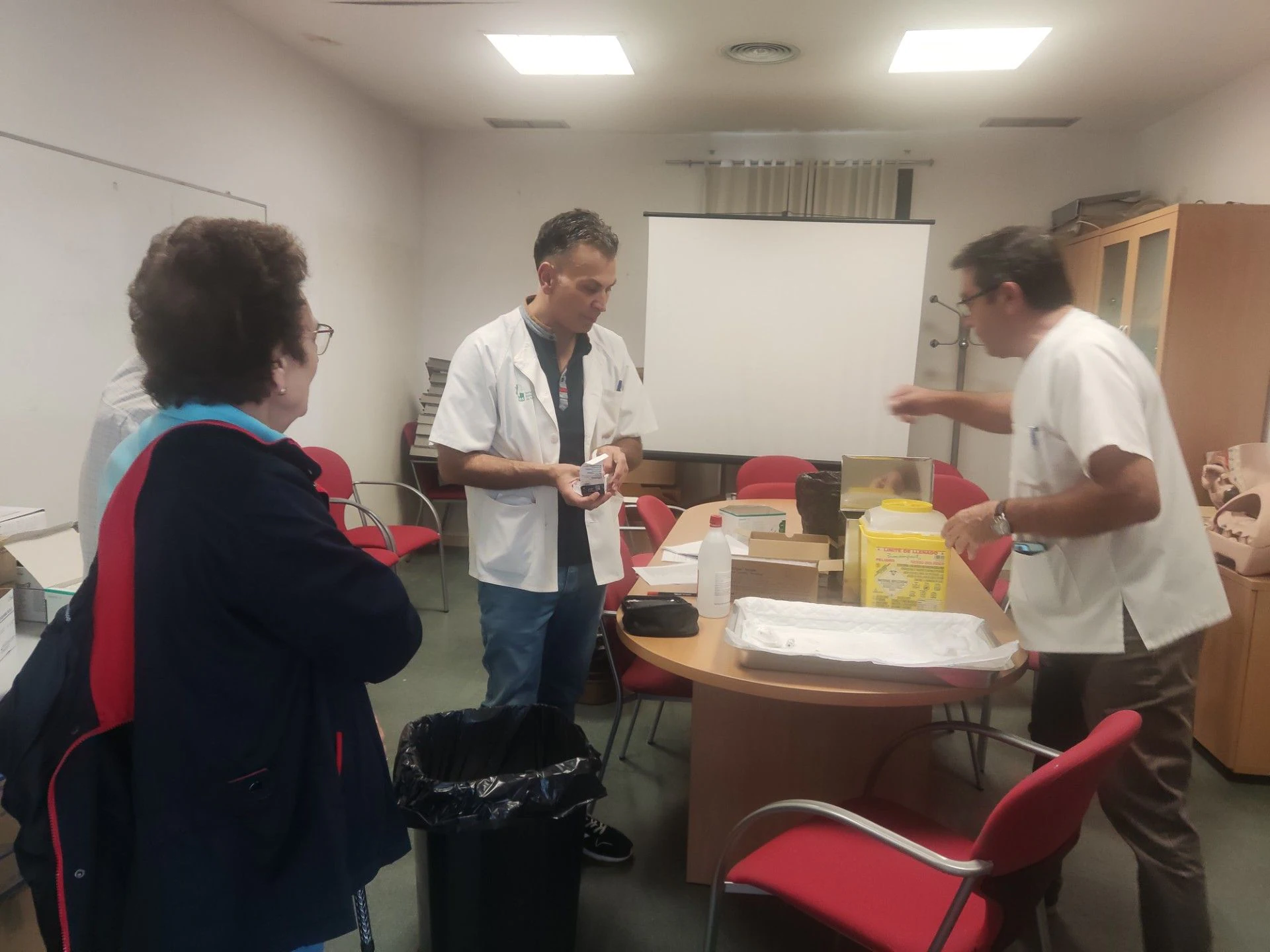 Nurses caring for elderly patients receiving vaccinations.