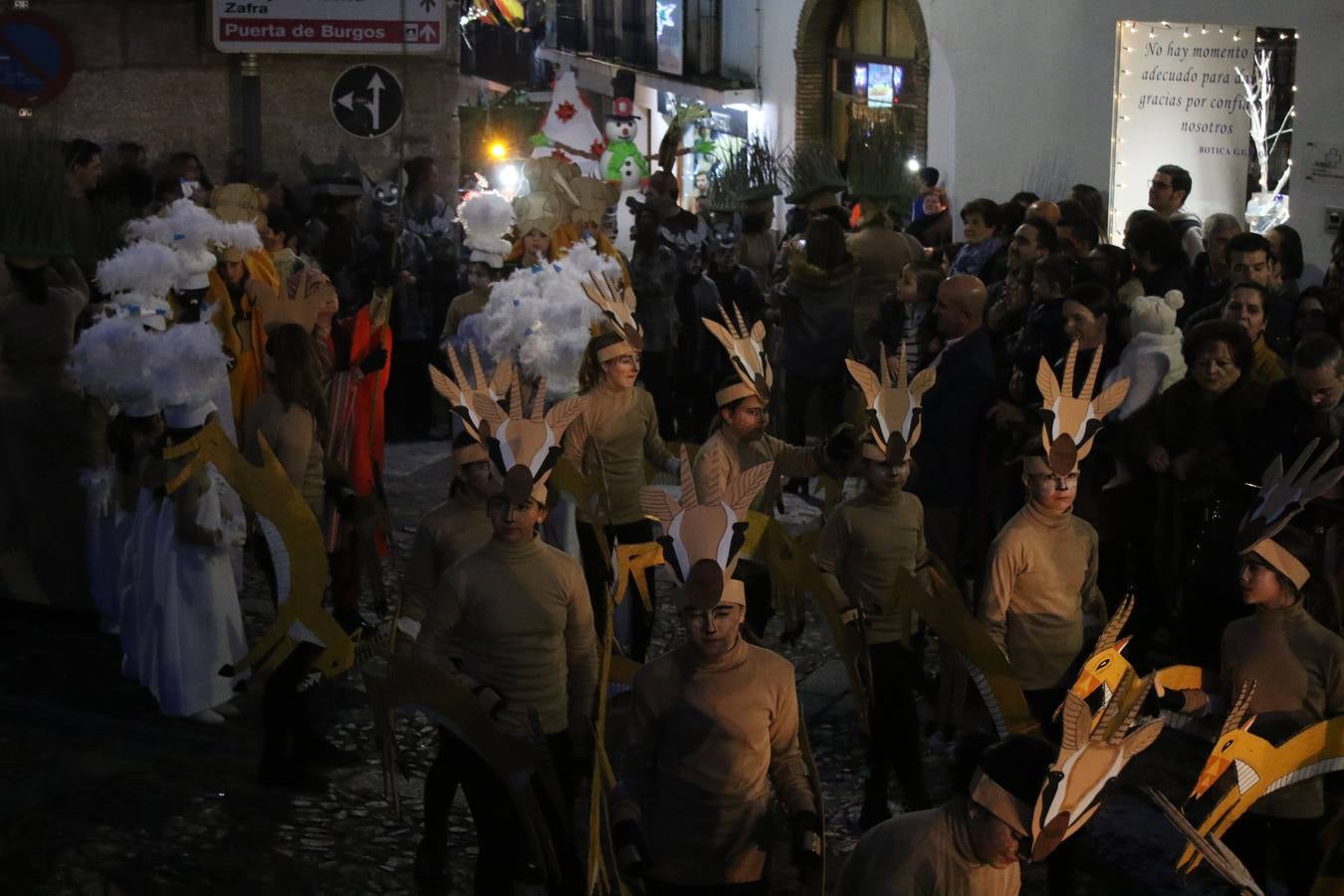 Jerez de los Caballeros se inundó de magia, ilusión y colorido con su tradicional Cabalgata de Reyes Magos. Primero, fueron los mayores de la Residencia Hernando de Soto quienes disfrutaron de la presencia de sus Majestades de Oriente junto a la visita de autoridades y miembros de las distintas cofradías y hermandades. Desde el Ayuntamiento se había dispuesto este año un recorrido distinto y el el entorno del citado centro, junto al parque de Santa Lucía, fue el punto de partida de una cabalgata que vivió uno de sus momentos más extraordinarios en la Plaza de España con mucha presencia de público. Junto a los tronos de Melchor, Gaspar y Baltasar, carrozas realizadas por el Ayuntamiento, destacó la participación de asociaciones y colectivos: vecinos de La Bazana, 'Euexia Rural', la Asociación cultural del Belén Santa Ángela y la Asociación juvenil 'La Trouppe', que con más de 100 componentes ofreció un gran espectáculo con la recreación de la fantasía de 'El Rey león'. La música acrecentó el ambiente de ilusión, con los sones de la Agrupación Musical 'Nuestro Padre Jesús Nazareno' y la Agrupación Musical 'Maestro Sousa' de la OJE. Los más pequeños vivieron la cita con emoción y fueron los verdaderos protagonistas del mejor prólogo de una de las noches más especiales del año.Además del amplio despliegue de fantasía y colorido, estuvo la labor de: Policía Local, Cruz Roja, Protección Civil, Bomberos, Guardia Civil, para el buen desarrollo de este evento.