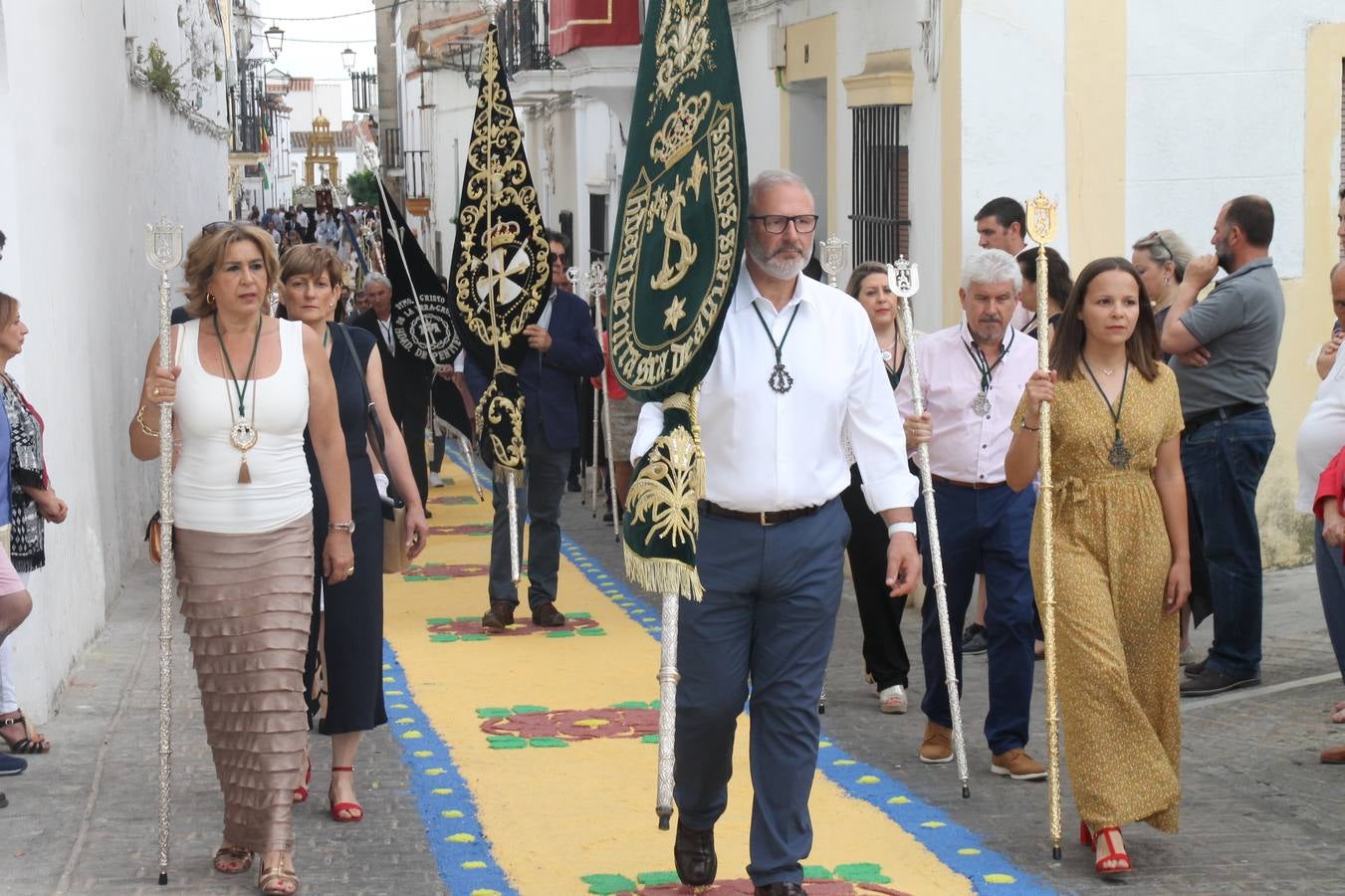 Jerez de los Caballeros celebró ayer la festividad del Corpus Christi en medio de un ambiente de solemnidad y convivencia del que fueron partícipes cientos de personas.La iglesia visigoda de Santa María de la Encarnación, llena de fieles, acogió la celebración de la Eucaristía que dió paso a la procesión acompañando la Santa Custodia en el magnífico templete de la iglesia de San Miguel, sobre las andas de la Virgen de Aguasantas y portada por costaleros y costaleras de la recién Asociación creada en esta ciudad. El párroco, Antonio María Rejano, destacó la significación de esta procesión, lamás grande, dijo, «porque Jesús sale a nuestras vidas, a nuestro encuentro y nosotros le acompañamos». Al término de la misa, incidió en el agradecimiento a todas las personas que han participado para hacer posible su desarrollo, trabajando desde la jornada del sábado en la elaboración de las preciosas alfombras de sal teñida de colores, que lucieron en las calles del centro de Jerez. El agradecimiento fue especial para los padres y madres de los niños y niñas que han hecho la Primera Comunión, para éstos mismos, también para catequistas, Cofradías y Hermandades, la Asociación del costaleros y costaleras de la Semana Santa de Jerez de los Caballeros, Ayuntamiento, Policía Local, grupos y personas de la parroquia.Autoridades civiles en representación del Ayuntamiento, Policía Local y Guardia Civil, acompañaron el desarrollo de la procesión junto a representantes de todas las cofradías y hermandades jerezanas y el protagonismo de los más de 80 niños y niñas que este año han celebrado su Primera Comunión.  A lo largo de todo el recorrido se instalaron distintos altares, también con la colaboración de vecinos y centros como la Residencia de Mayores Hernando de Soto. Los magníficos sones de la Agrupación Musical 'Nuestro Padre Jesús Nazareno' coronaron esta hermosa procesión.