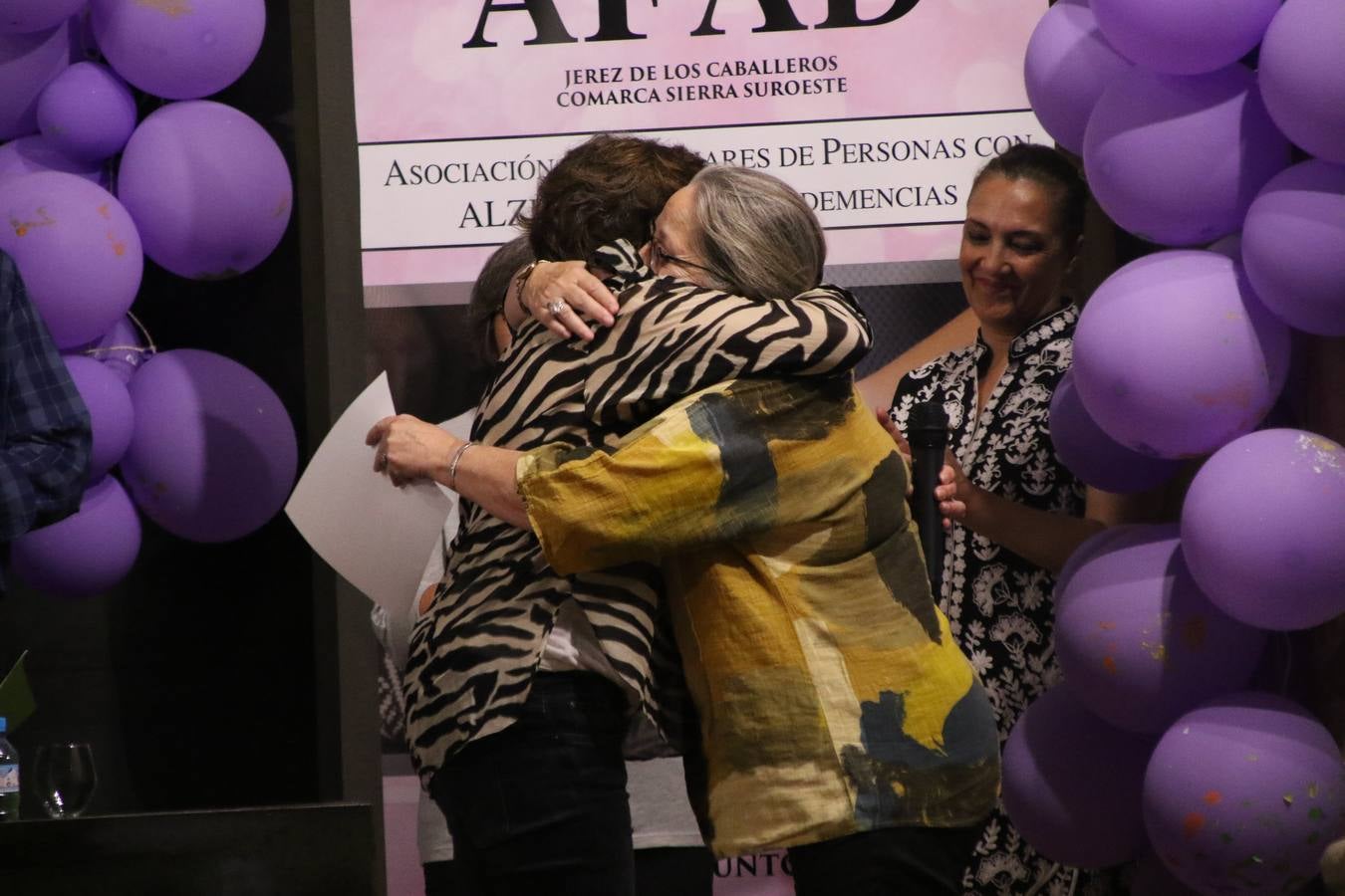 Ante las condiciones climatológicas adversas, el auditorio del Conventual San Agustín se convirtió en el mejor escenario para acoger las actividades que, con motivo del Día Mundial del Alzhéimer, la Asociación de Familiares de Personas con Alzheimer y otras Demencias de Jerez de los Caballeros y Comarca Sierra Suroeste (AFAD) había preparado en el municipio. Una gran pancarta con el lema 'Evolución', realizada por los alumnos del Colegio de Educación Especial 'Nuestra Señora de Aguasantas', presidió el escenario, y una marea de globos morados con distintos dibujos, realizados por los alumnos de los colegios 'Sotomayor y Terrazas' y 'El Rodeo', tiñó de color, empatía, sensibilidad y creatividad el citado auditorio.La jornada comenzó con la canción 'Estoy contigo' de la Oreja de Van Gogh. A continuación, tuvo lugar una mesa redonda en la que cinco personas contaron su testimonio en relación a esta enfermedad. Posteriormente, se dio paso a la lectura de un manifiesto; la entrega de diploma a las personas y colectivos colaboradores, y la lectura de dos cuentos infantiles.
