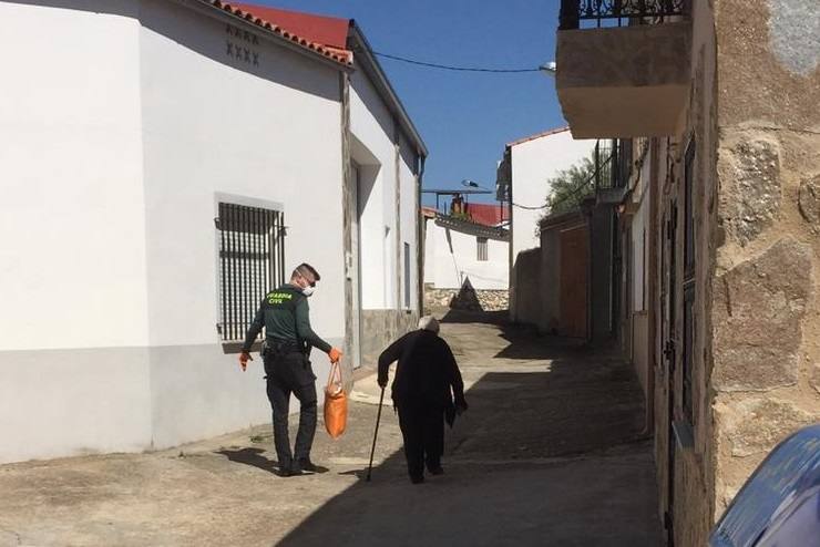 Un Guardia Civil de Miajadas ayuda a una vecina mayor a llevar la compra 
