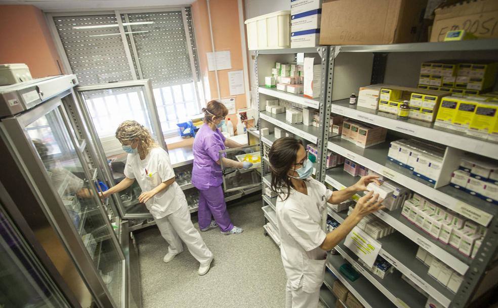 Dos enfermeras y una auxiliar seleccionan medicamentos en la farmacia del Hospital San Pedro de Alcántara de Cáceres 