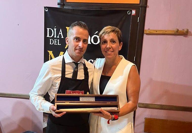 Juan Carlos Garrido recibe el Cuchillo Jamonero de Plata de manos de Loli Vargas, alcaldesa de Monesterio