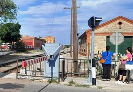 Paso a nivel de Pablo Luengo con la estación al fondo