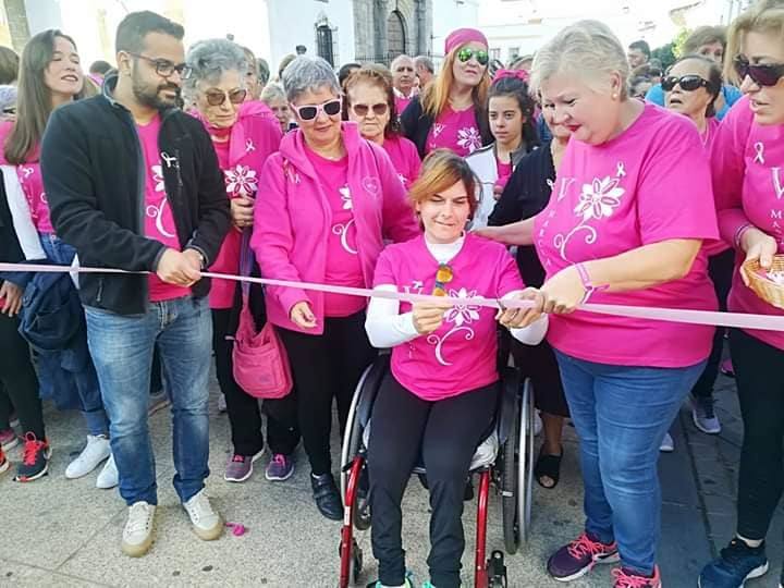 Imagen secundaria 1 - Arriba, parte del equipo de Sonríe Olivenza, entidad organizadora del evento. Abajo, a la izquierda, momento en que la piragüista oliventina, Inés M. Felipe, cortaba la cinta de la salida de la marcha. A la derecha, familia Pérez-López, provenientes de Alconchel, una de las muchas localidades presentes en el evento solidario. 