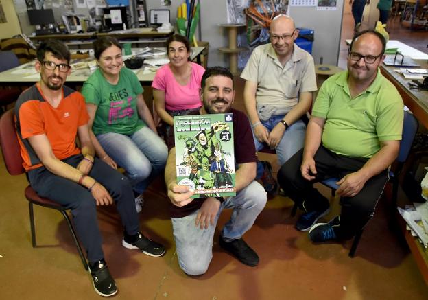 Alejandro de la Fuente, junto a sus alumnos del taller de cómic, muestra la portada del primer número de 'Inclusion Man'. :: casimiro moreno