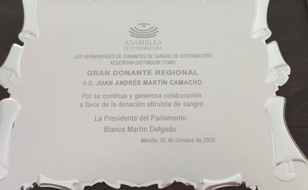 Imagen principal - Juan Andrés, su cartilla de donaciones y el reconocimiento que le han otorgado. 