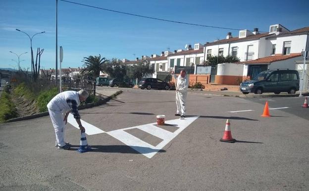 Operarios pintando señales en la barriada del Perú 