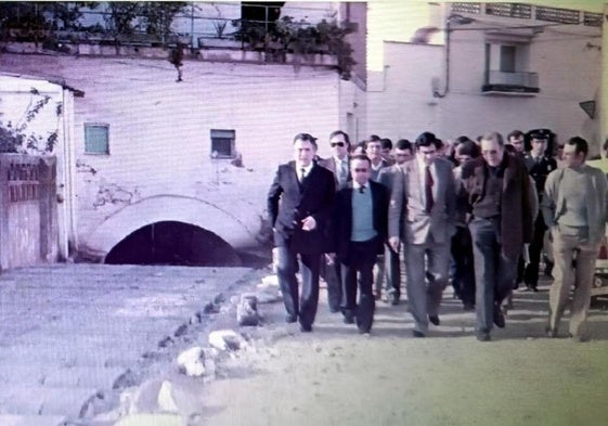 Visita del gobernador a las obras de canalización. Le acompañana el alcalde Antonio Rabel, el secretario Juan Rastrollo, el juez de paz Luis Ortiz, y el resto de la coprporación entre los que están José López 'El Portugués', Juan Benavides, César Cuéllar, Juan Delicado, Anselmo Antúnez y otras autoridades locales. Al fondo, el edificio.