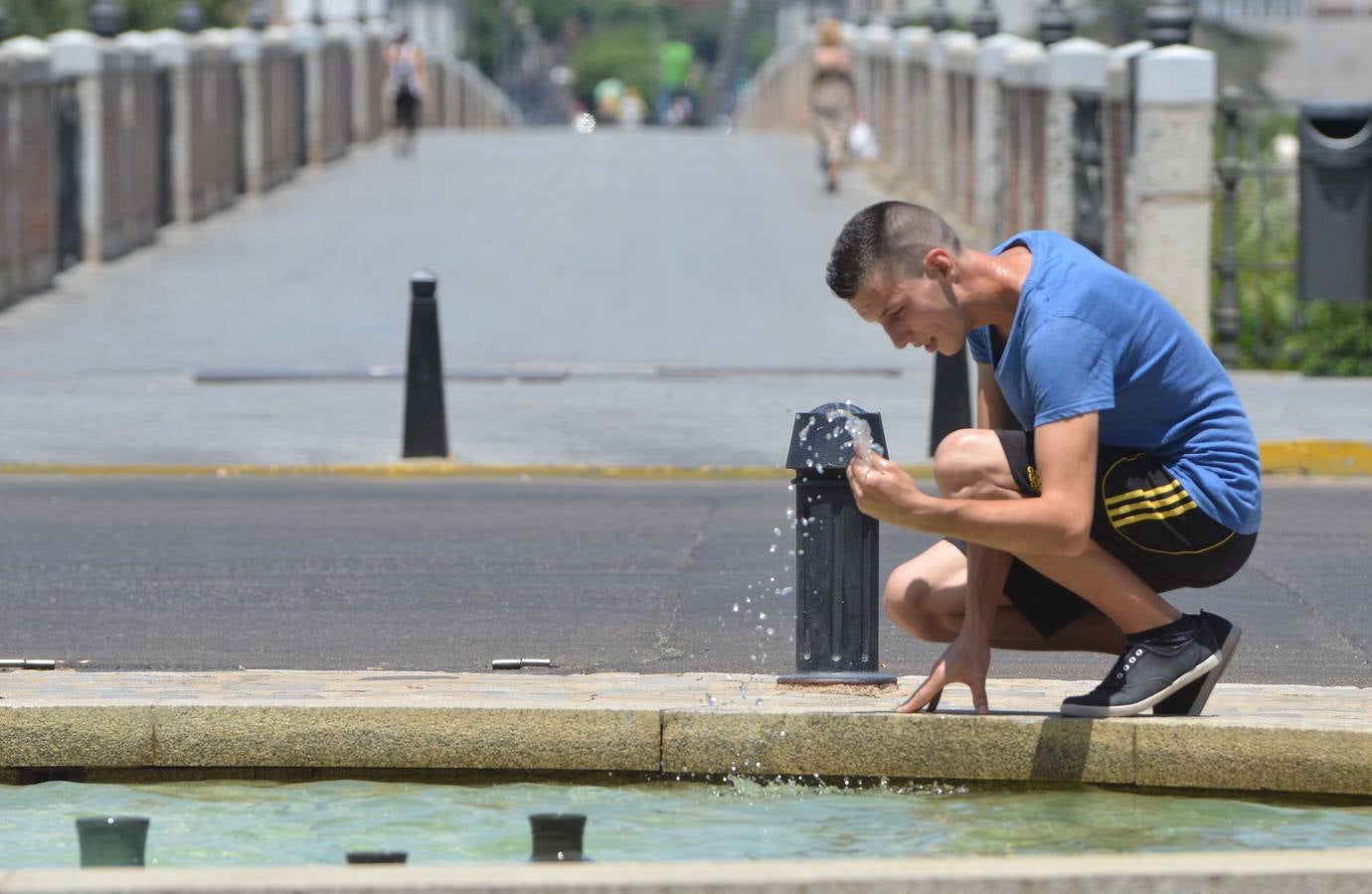 Un joven se refresca en la fuente de Puerta de Palmas en Badajoz. Foto: Casimiro Moreno
