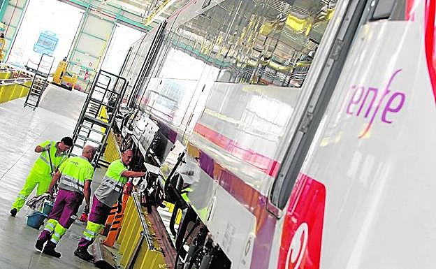 Personal trabajando en un tren en el taller de Renfe en Cádiz.