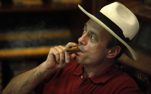 Un turista fuma un puro Caoba en una tienda de Santo Domingo. 