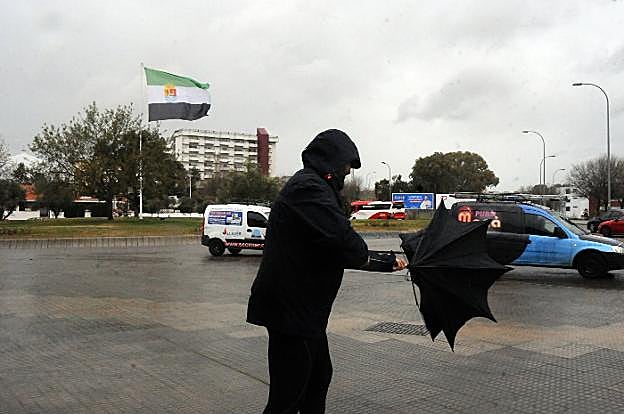 Una mujer bajo la lluvia en Badajoz. :: j. v. arnelas