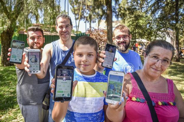 Cinco miembros de la comunidad Pokémon GO Badajoz muestran la aplicación. :: j. v. arnelas