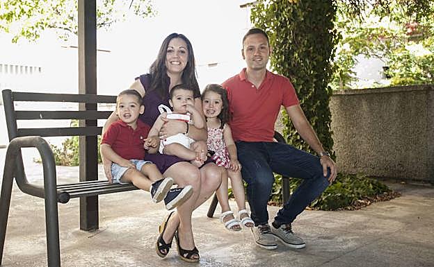 Julia Simón y Jesús Caletrio con Adrián, Samuel y Ruth en un parque cercano a su casa. :: JORGE REY