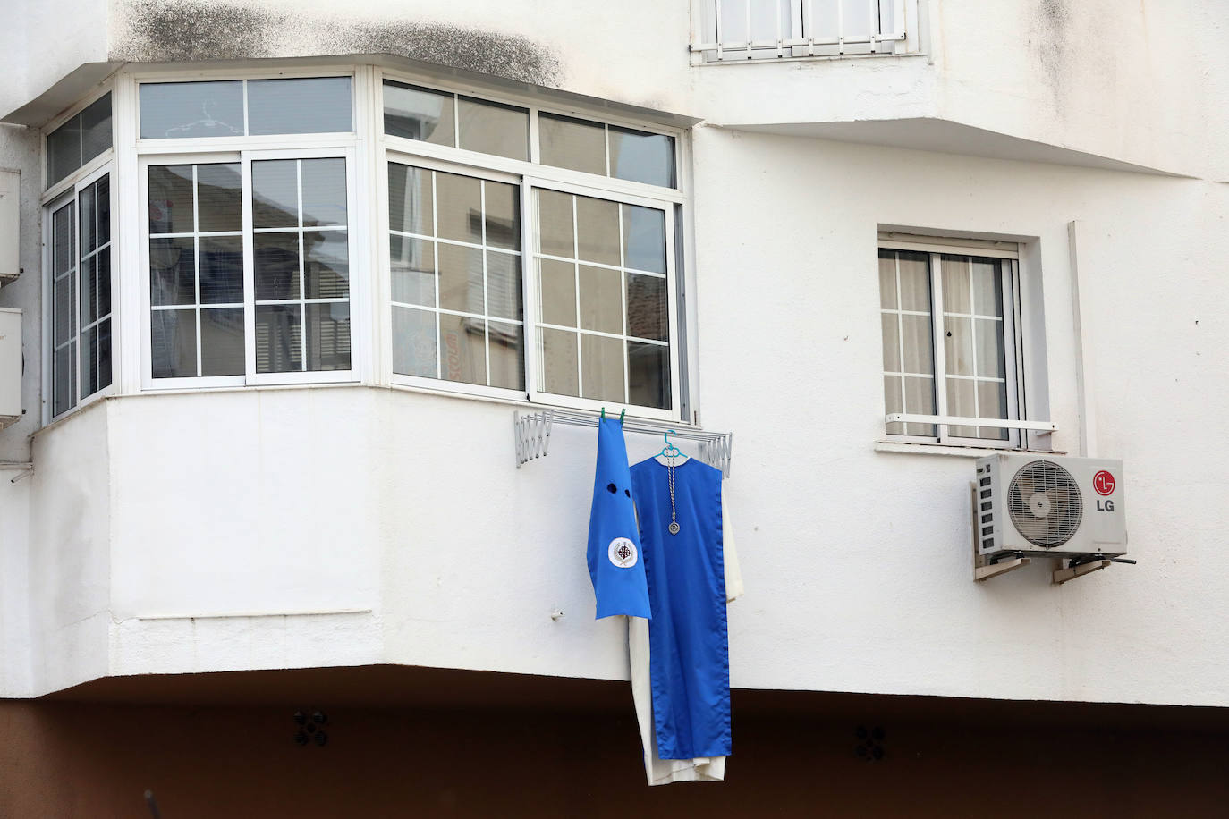 Los barrios como Nueva Ciudad sacan los colores y túnicas de nazarenos a los balcones