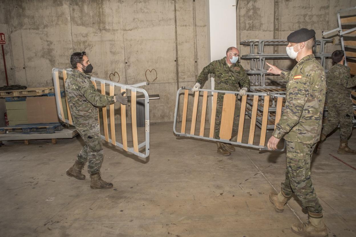 Los militares transportan camas al interior de Ifeba en la mañana del jueves. 