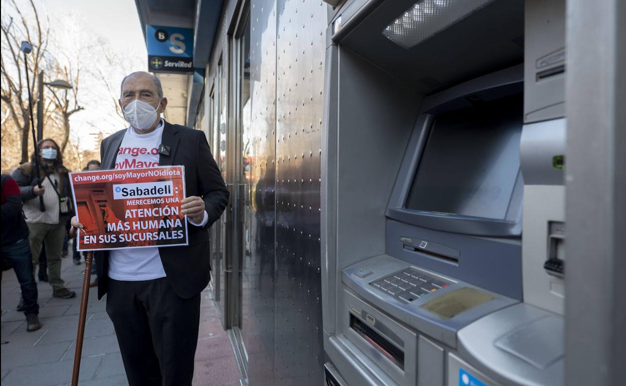 El popular jubilado Carlos San Juan, frente a una entidad financiera.