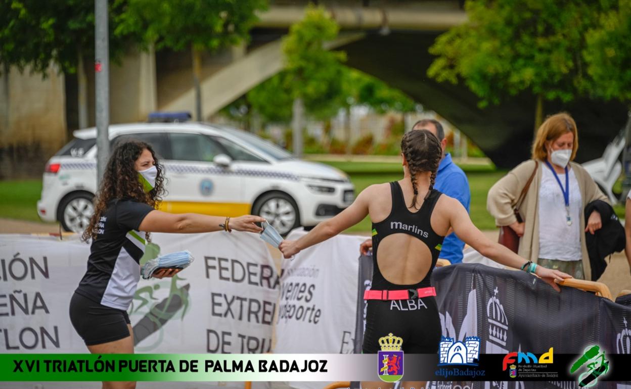 Imagen anunciadora del Triatlón Puerta de Palma Badajoz. Al fondo, un coche de la Policía Local.