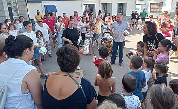Imagen principal - Arriba, morteros en el carrusel de juegos tradicionales. A la izquierda, Miguel Ángel Castellano y Agustina Ortiz, posando tras terminar de cocinar la paella popular. A la derecha una de las tortillas participantes en el concurso gastronómico, obra de la cocinera local Isabel María Díaz González. 