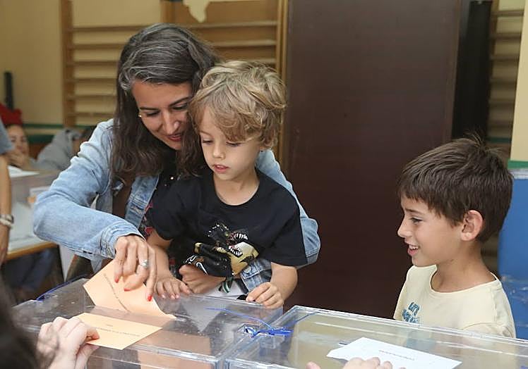 Irene de Miguel votando con sus hijos pequeños.