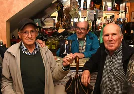 Vecinos de Viandar, en el bar La Plaza, con la foto de Valverde que decora el establecimiento.