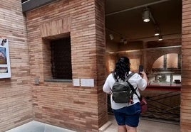 Una mujer observa una exposición del Museo Nacional de Arte Romano de Mérida sobre el interior de una 'domus'.