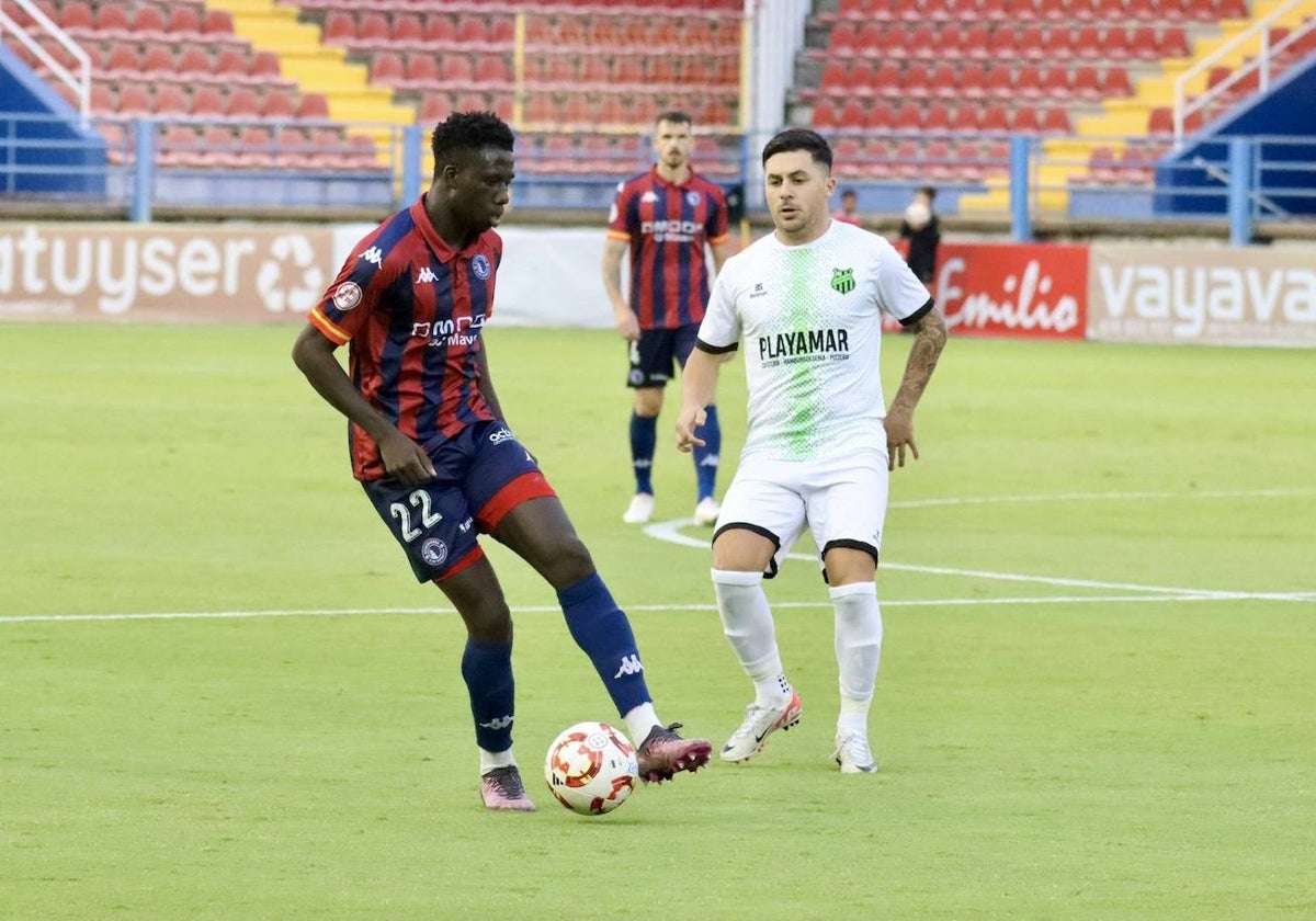 Moussa controla el balón ane la pesión de un rival.