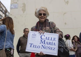 La hija de María Telo posa junto a una placa conmemorativa en la calle dedicada a su madre.