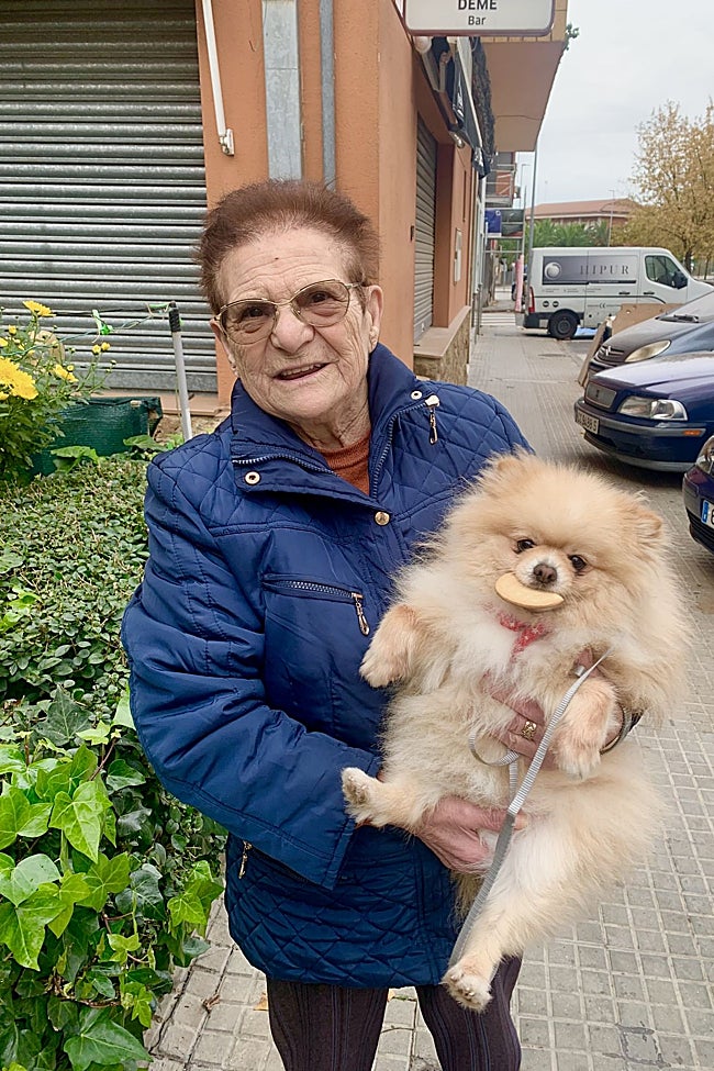 La mujer sostiene a Pepino en brazos mientras se come una galleta.