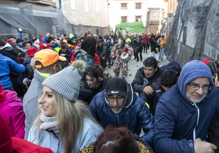 El público intenta protegerse para no recibir impactos durante el ajusticiamiento de Jarramplas.