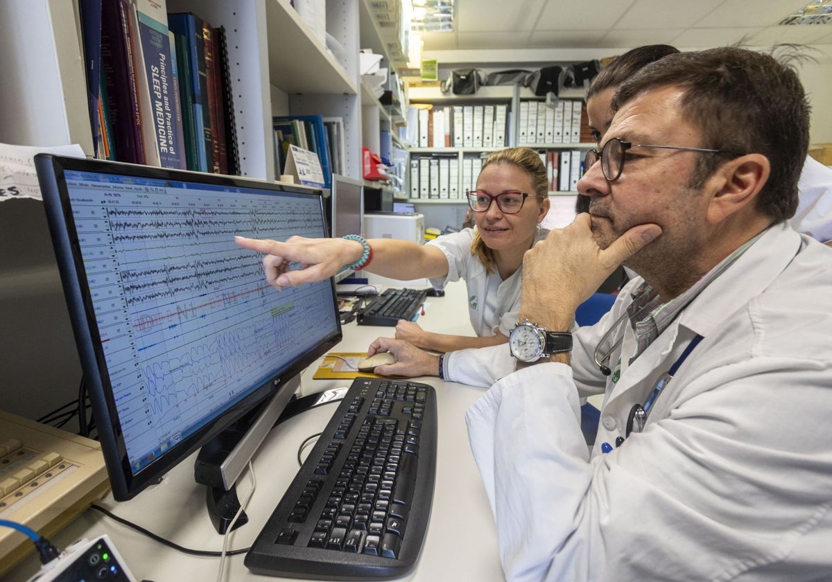 Jaime Corral viendo el estudio del sueño de un paciente junto a dos compañeras de la Unidad del Hospital San Pedro de Alcántara de Cáceres.