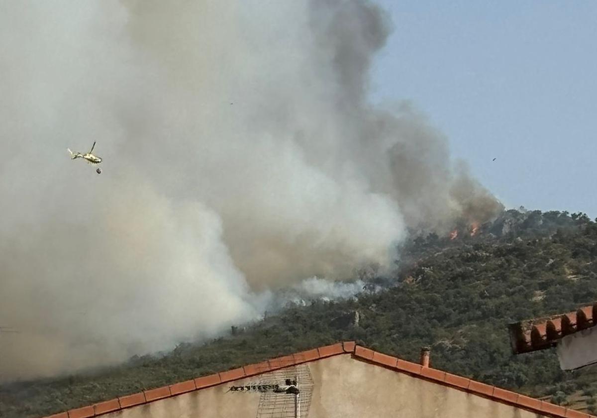 Un helicóptero se dirige a las llamas en Oliva de Mérida.