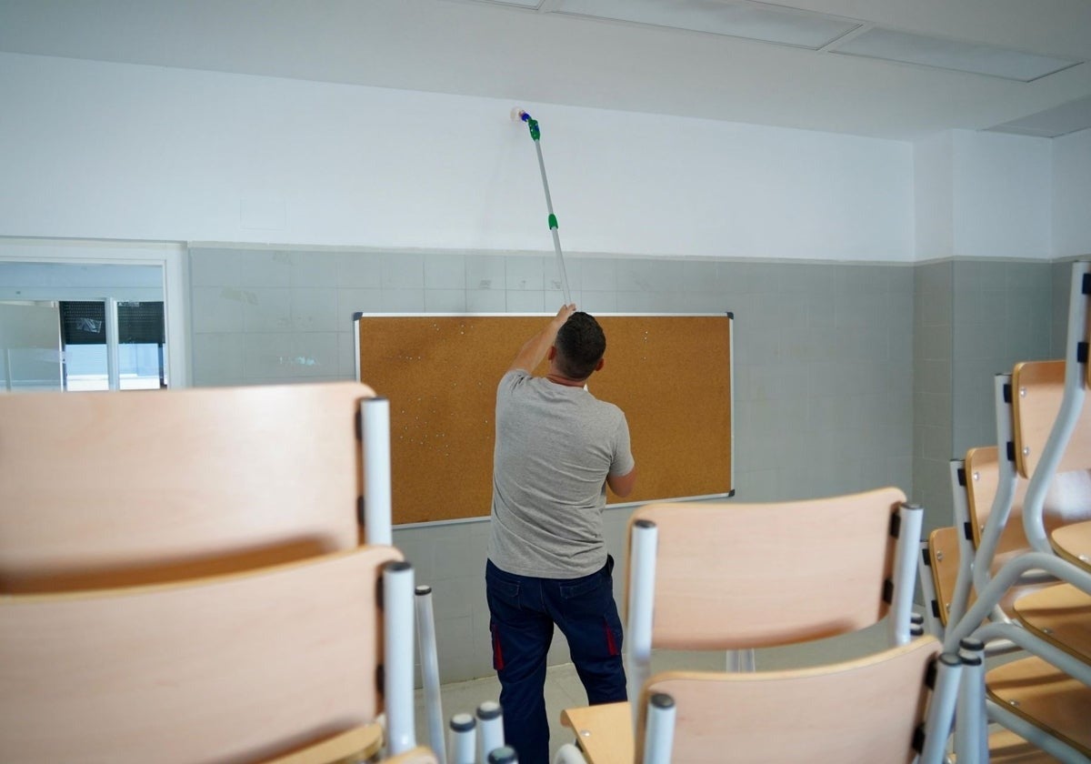 Un operario pinta un aula en un colegio de Badajoz.