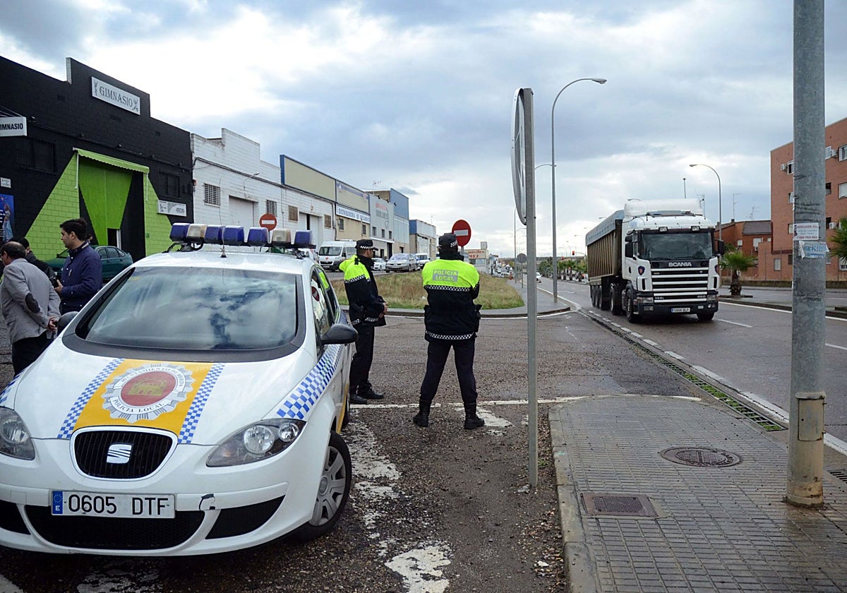 Un coche de la Policía junto a varios agentes.