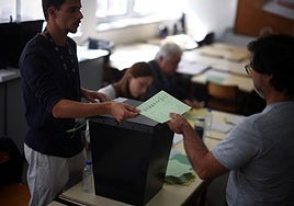 Un miembro de la mesa electoral entrega una papeleta a un votante durante las elecciones locales en Lisboa, este domingo el 12 de octubre de 2025.