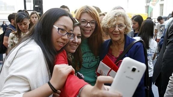 Carmena se fotografía junto a algunos asistentes en el Madrid Student Welcome Day. 