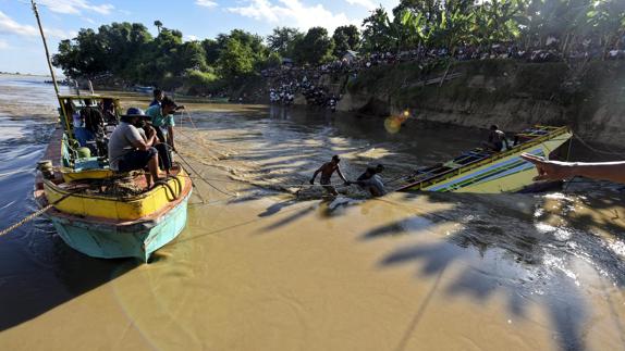 Miembros de los servicios de rescate intentan reflotar un barco hundido en el río Chindwin.