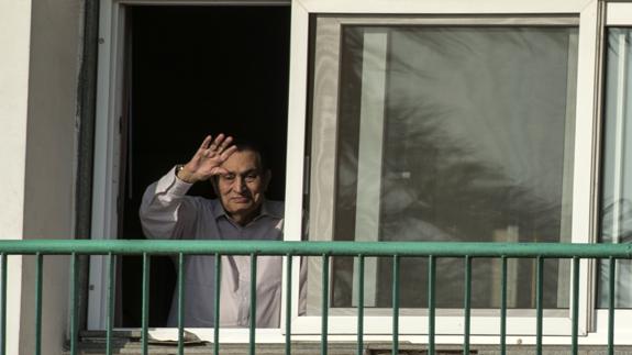 El expresidente egipcio Hosni Mubarak saluda a los simpatizantes desde su habitación de un hospital de El Cairo.  