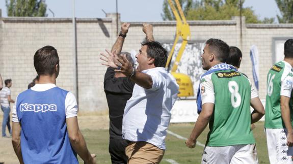 Adolfo, entrenador del Cacereño, celebra la victoria con sus jugadores.