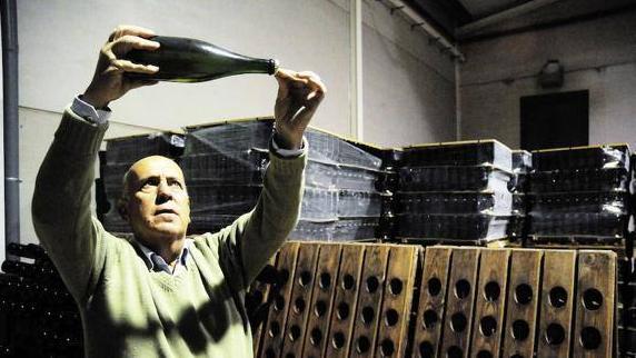 El bodeguero Marcelino Díaz, de Almendralejo, con una botella de cava en sus instalaciones. 