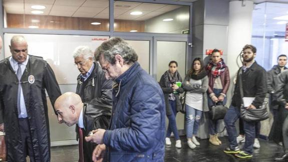 El exdirector, con abrigo azul, y con el pelo blanco el excomercial, ayer, durante el juicio. :: 