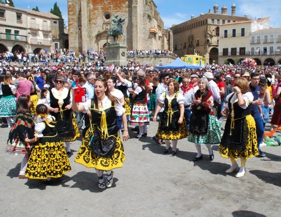 Un grupo de mujeres con el traje regional se hace un selfi en la plaza Mayor de Trujillo. :: jsp