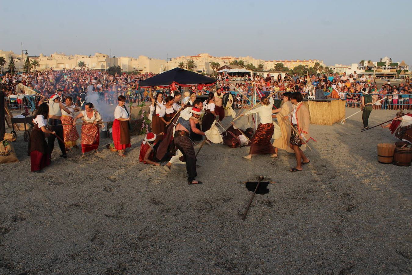 Miles de personas disfrutaron en la tarde noche de ayer con el Desembarco Pirata en la playa de Poniente de Almerimar. Una actividad que cada año gana en adeptos y que ayer permitió volver a acercar un trocito de la historia de esta zona a los asistentes. Un evento de gran plasticidad y trepidante ritmo que se vivió en la playa desde donde luego partió un colorido y animado pasacalles que recorrió el Puerto Deportivo para acabar en la Plaza Batel.