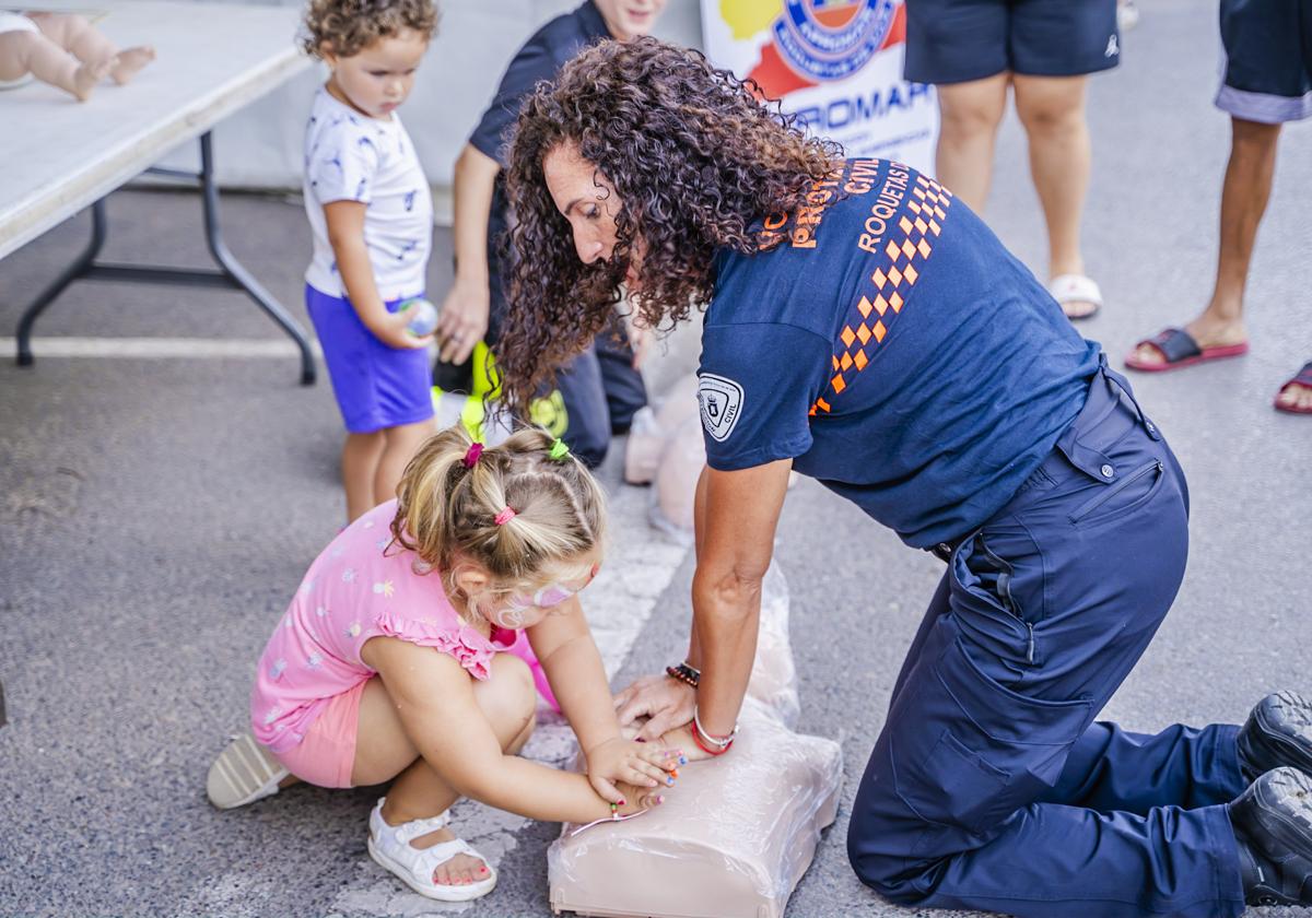 Una voluntaria de Protección Civil de Roquetas enseña como hacer una Reanimación cardiopulmonar (RCP).