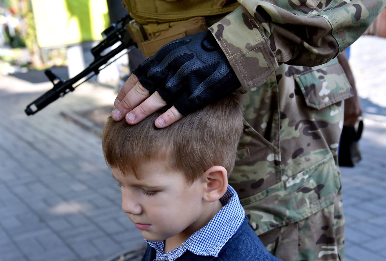 Un miembro del batallón de voluntarios junto a su hijo.