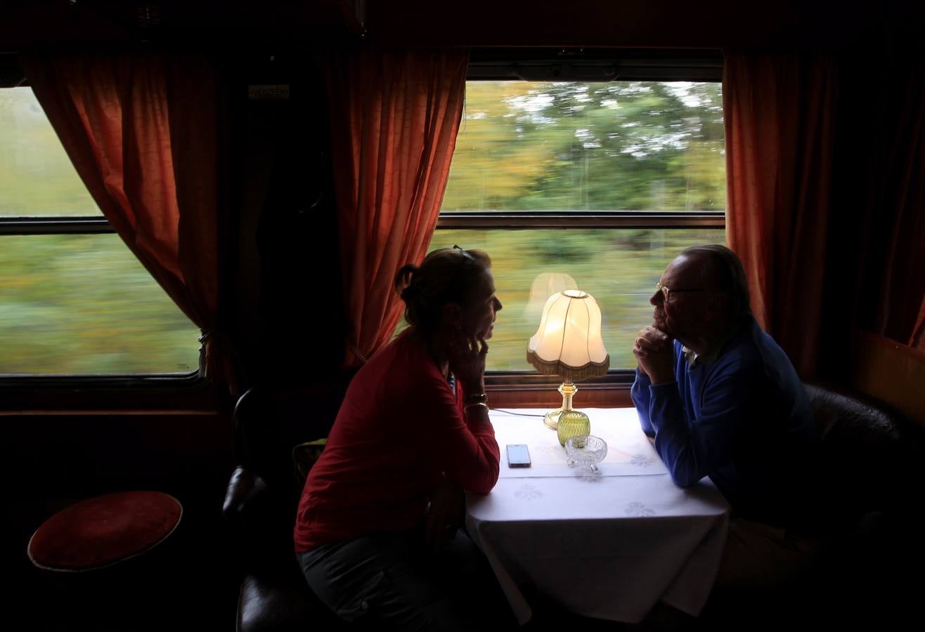 Los pasajeros miran por la ventana del coche restaurante de un histórico tren con destino a Teherán, ya que deja Budapest.