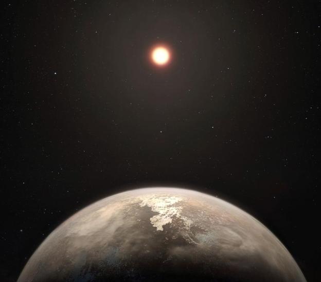 Esta recreación artística muestra al planeta templado Ross 128 b, que un equipo internacional de científicos ha descubierto, con su estrella enana roja anfitriona al fondo. 