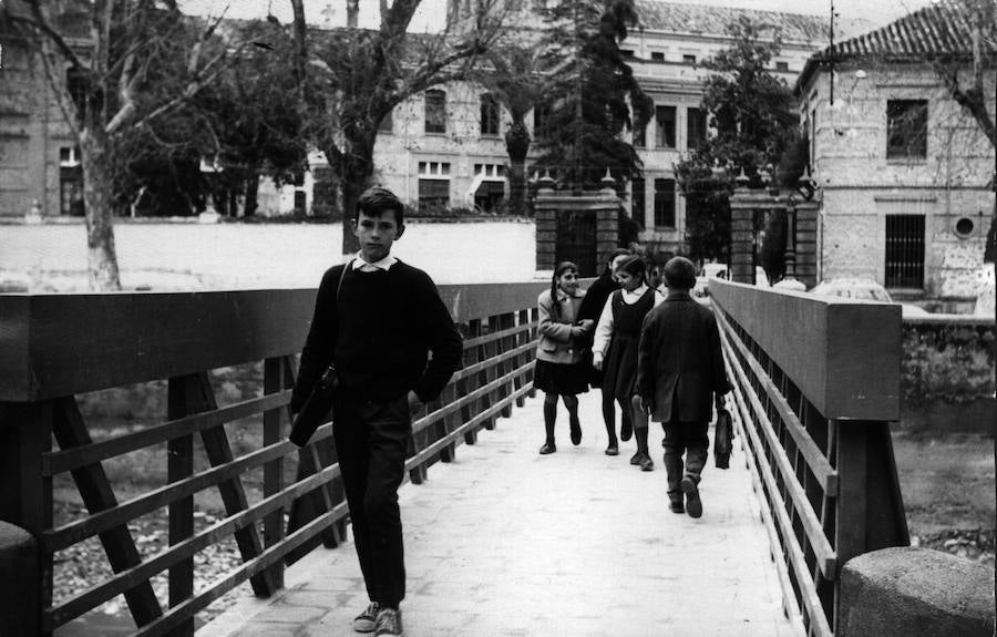 Niños cruzan por el puente de las Brujas que accede al colegio Sagrado Corazón, reconstruido tras ser arrastrado por las aguas del Genil en una tormenta. Año 1966 