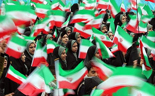Varias estudiantes ondean banderas iraníes durante una ceremonia por el 40º aniversario de la Revolución Islámica de 1979 este lunes en la plaza Azadi (Libertad) de Teherán (Irán). 